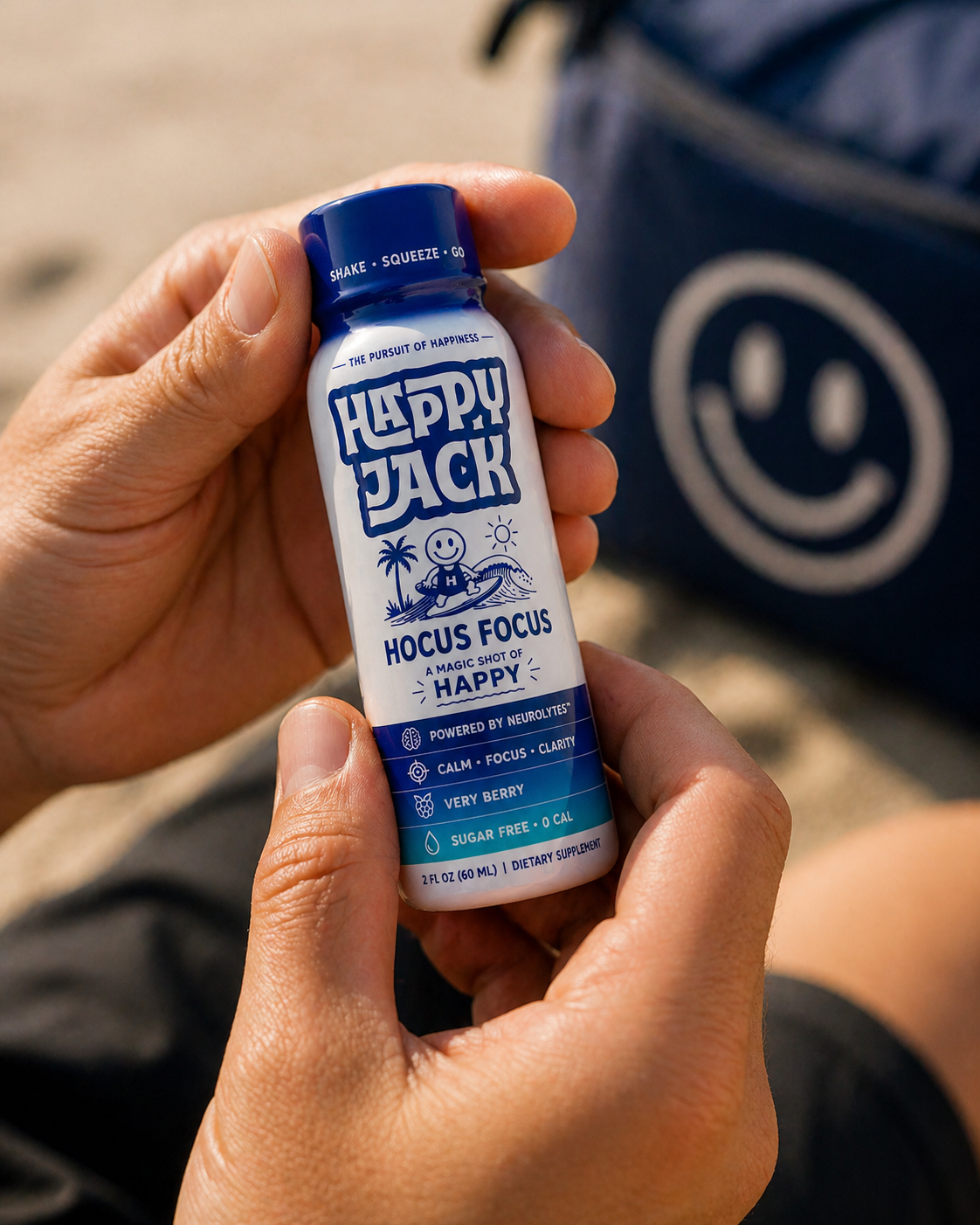 Hand holding a Happy Jack Hocus Focus shot at the beach